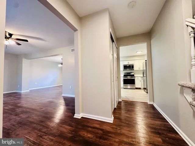 a view of a hallway with wooden floor