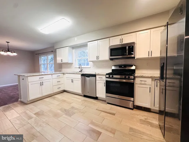 a kitchen with a stove a sink and a microwave