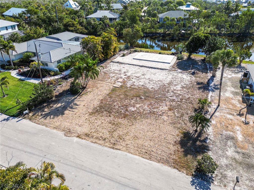 1016 Fish Crow Road Sanibel, FL 33957 - Photo 4 of 12 a pathway of a yard with potted plants