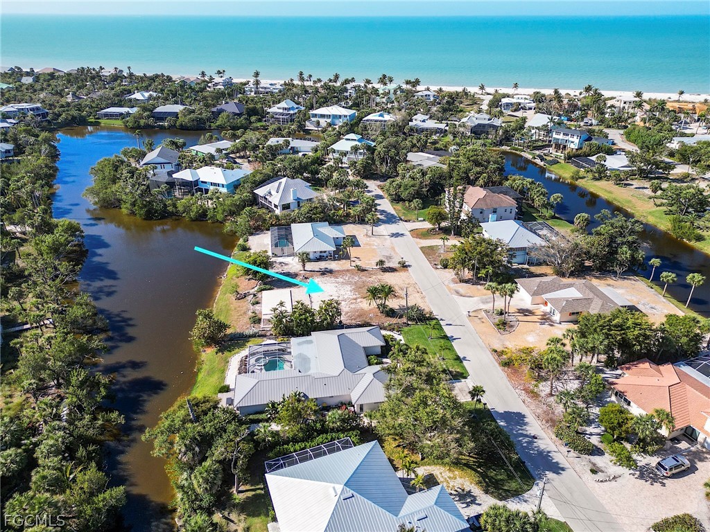 1016 Fish Crow Road Sanibel, FL 33957 - Photo 8 of 12 an aerial view of city and lake with trees all around