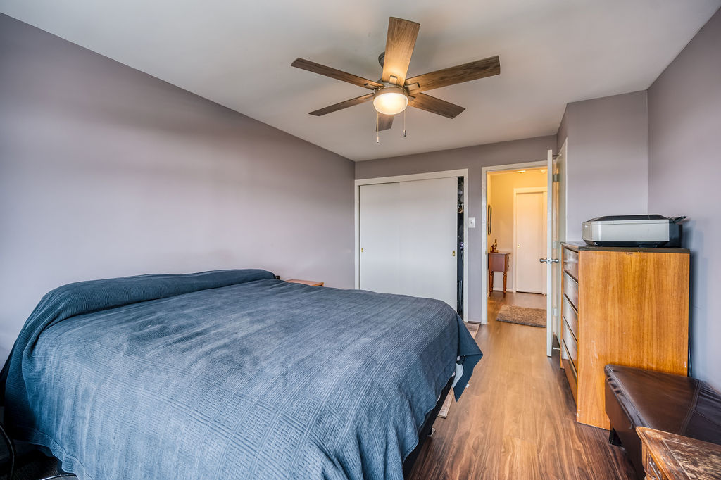 6030 North Sheridan Road, Unit 809 Chicago, IL 60660 - Photo 16 of 17 a bedroom with a bed and wooden floor