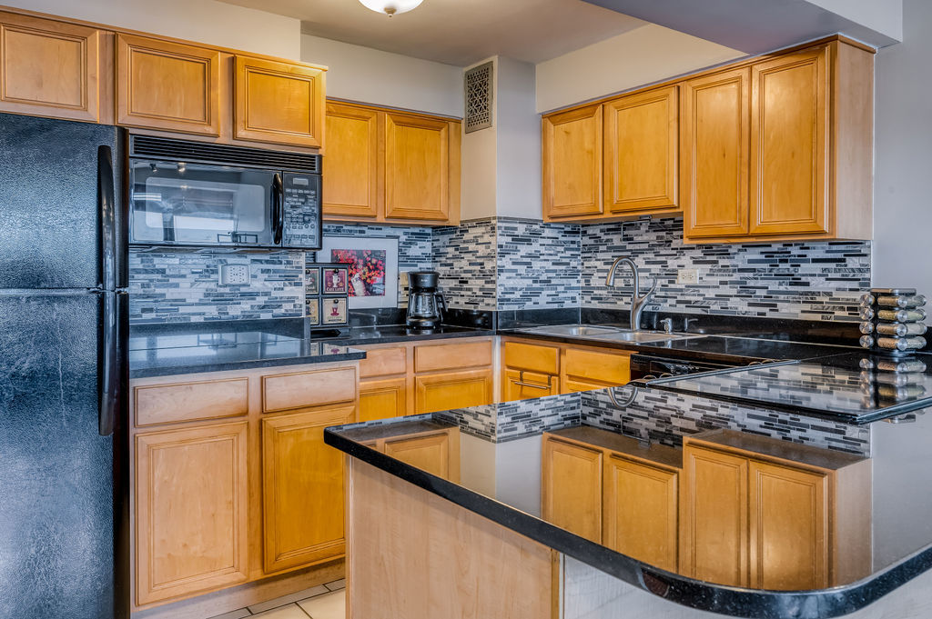 6030 North Sheridan Road, Unit 809 Chicago, IL 60660 - Photo 8 of 17 a kitchen with stainless steel appliances granite countertop a sink stove and granite counter top
