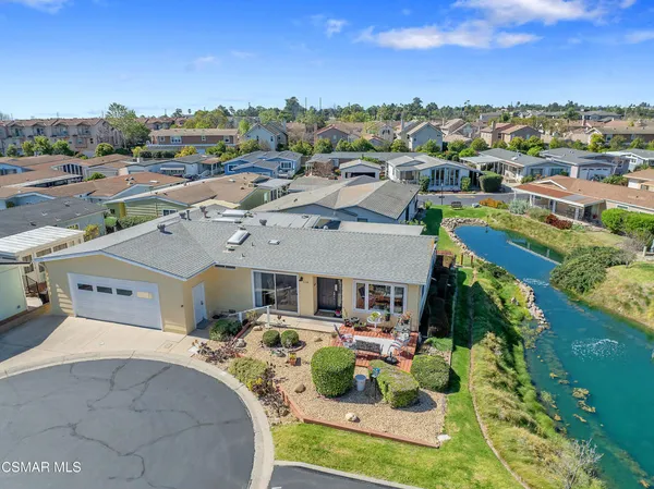 a aerial view of a house with a yard basket ball court and outdoor seating
