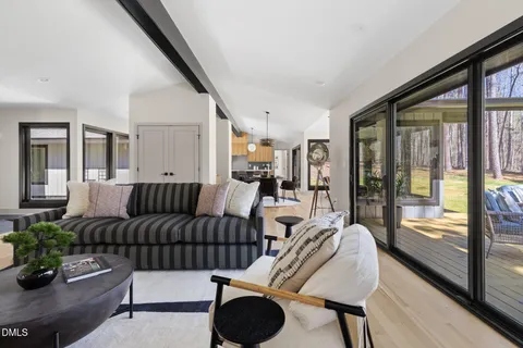 a dining room with furniture a chandelier and window