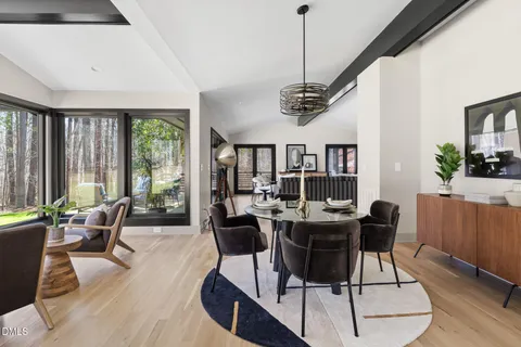 a large kitchen with stainless steel appliances a large counter top a stove and a refrigerator