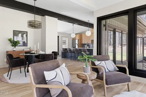 a large kitchen with kitchen island a large counter space a sink a window and stainless steel appliances