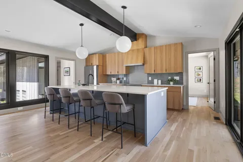 a kitchen with a refrigerator a sink and cabinets