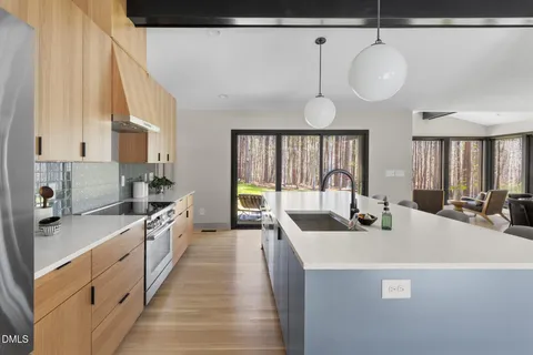 a bedroom with a bed window and mirror