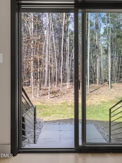a view of a workspace with furniture and window