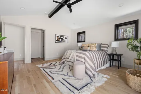 a room with a sink cabinets and a mirror