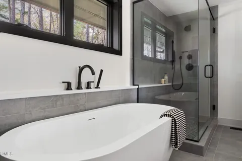 a view of a hallway with wooden floor and a window