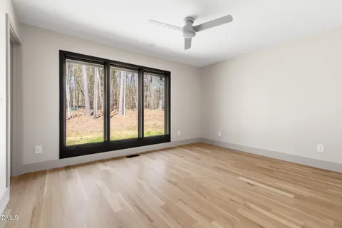 a view of a room with furniture and wooden floor