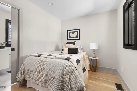 a view of a patio with table and chairs with wooden fence and floor