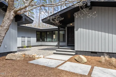 a living room with furniture a couch and potted plant