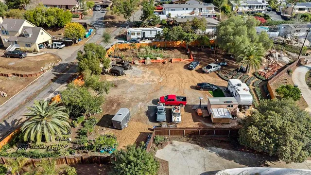 an aerial view of a house with a yard and lake view