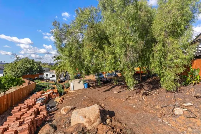 a view of a backyard with large trees
