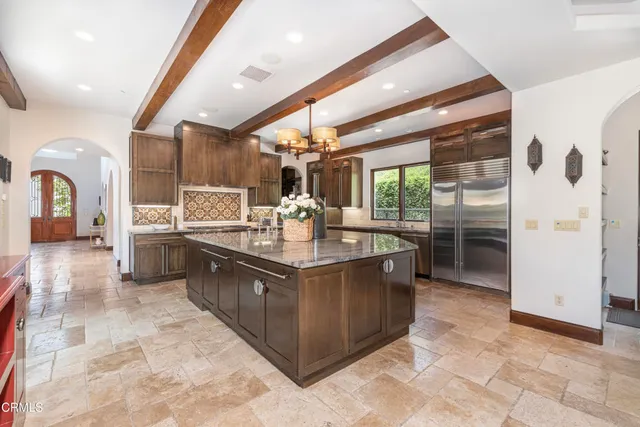 a bathroom with a granite countertop sink toilet a mirror and shower