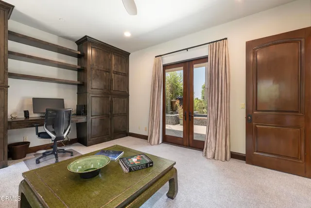 a view of a hallway with wooden floor and a bathroom