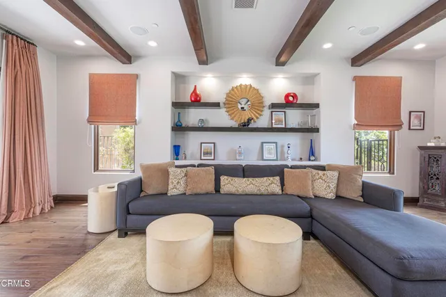 a view of a livingroom with wooden floor and a fireplace