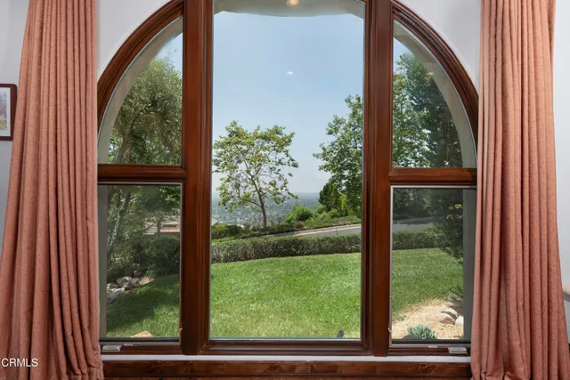a balcony with trees in front of it