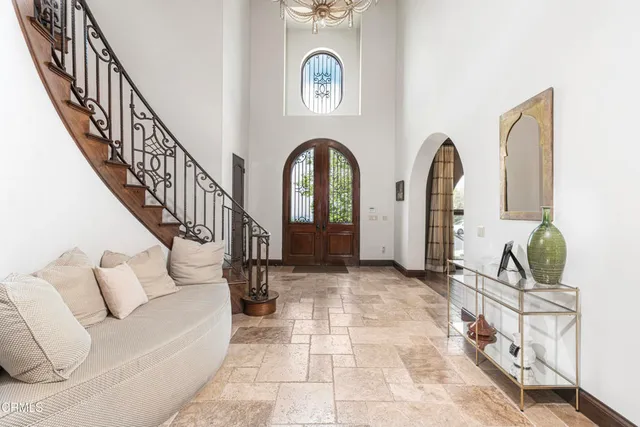 a large kitchen with stainless steel appliances a large counter top a stove a chimney a sink and cabinets