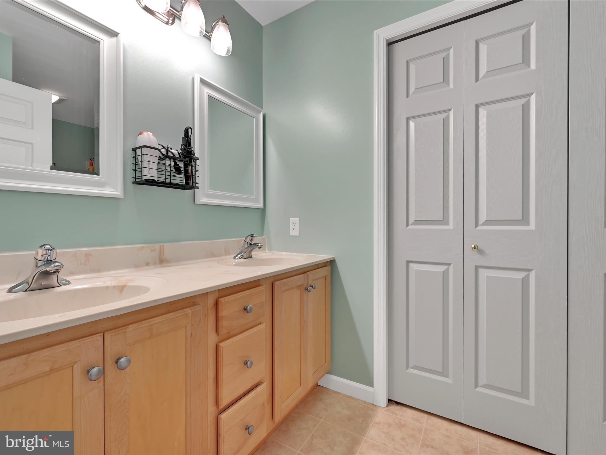 623 Courthouse Circle Lititz, PA 17543 - Photo 16 of 32 a bathroom with a double vanity sink and a mirror