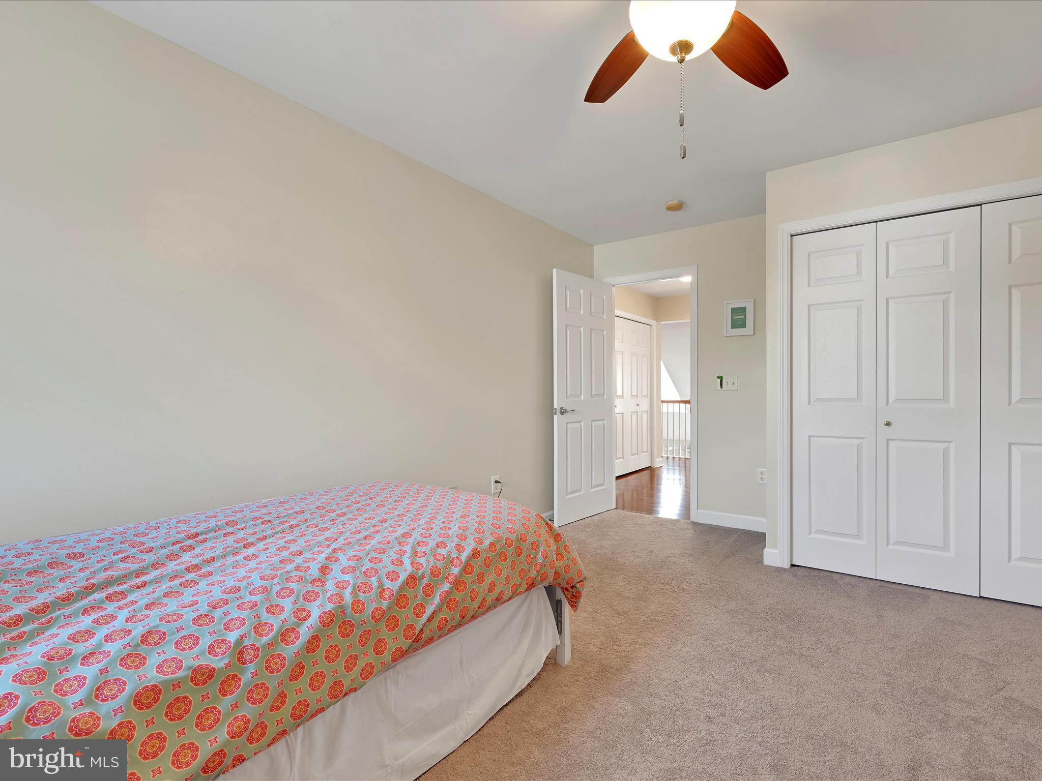 623 Courthouse Circle Lititz, PA 17543 - Photo 25 of 32 a bedroom with a large bed and a chandelier
