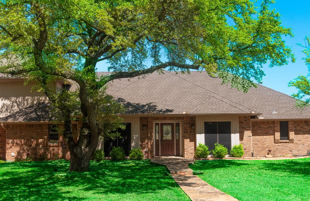 13 Crestview Circle Rockwall, TX 75087 - Photo 2 of 37 a front view of a house with a garden and plants