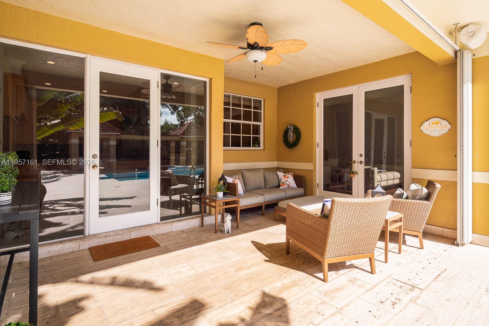 5770 Southwest 128th Street Pinecrest, FL 33156 - Photo 8 of 37 a outdoor space with patio the couches and a dining table with the view of the house