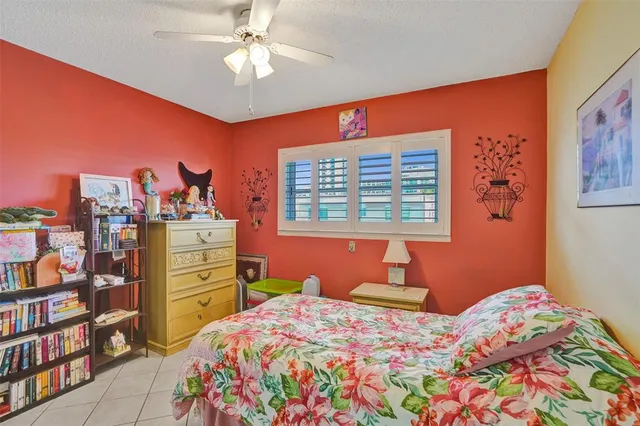 a bedroom with a bed and a bookshelf