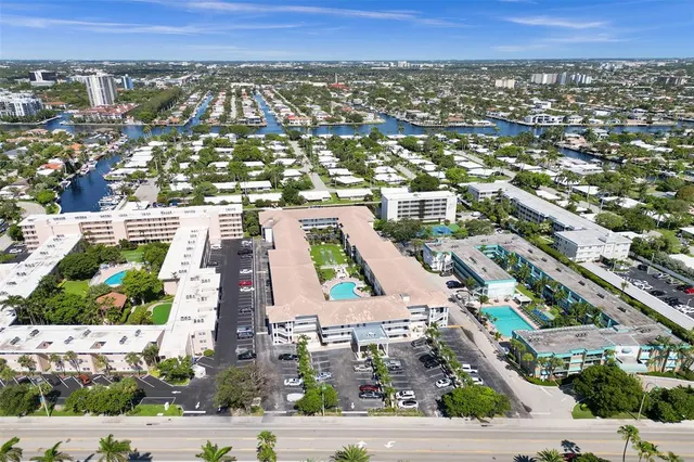 an aerial view of residential houses with outdoor space and street view
