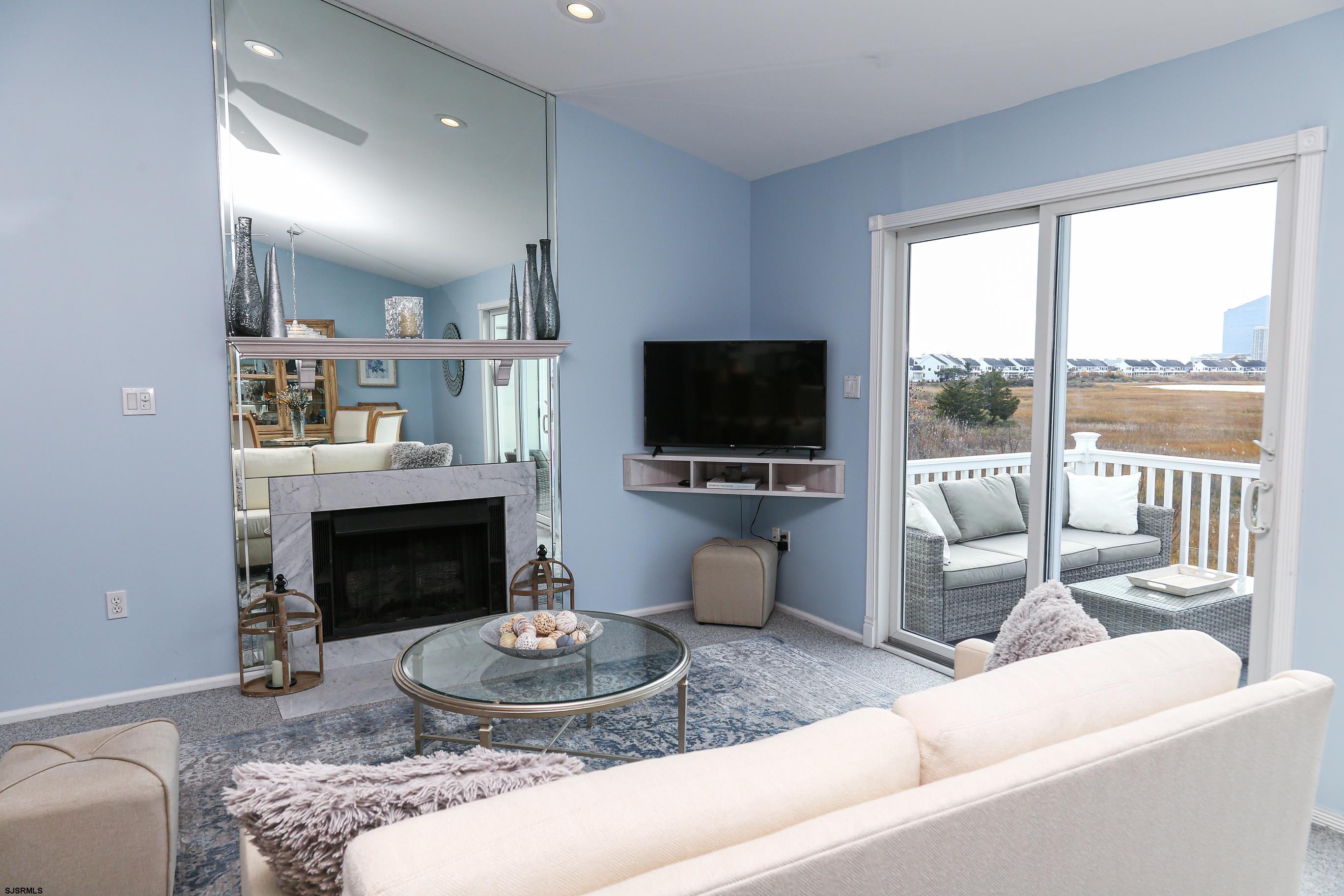 12 Gull Cove Brigantine, NJ 08203 - Photo 11 of 50 a living room with furniture a flat screen tv and a fireplace