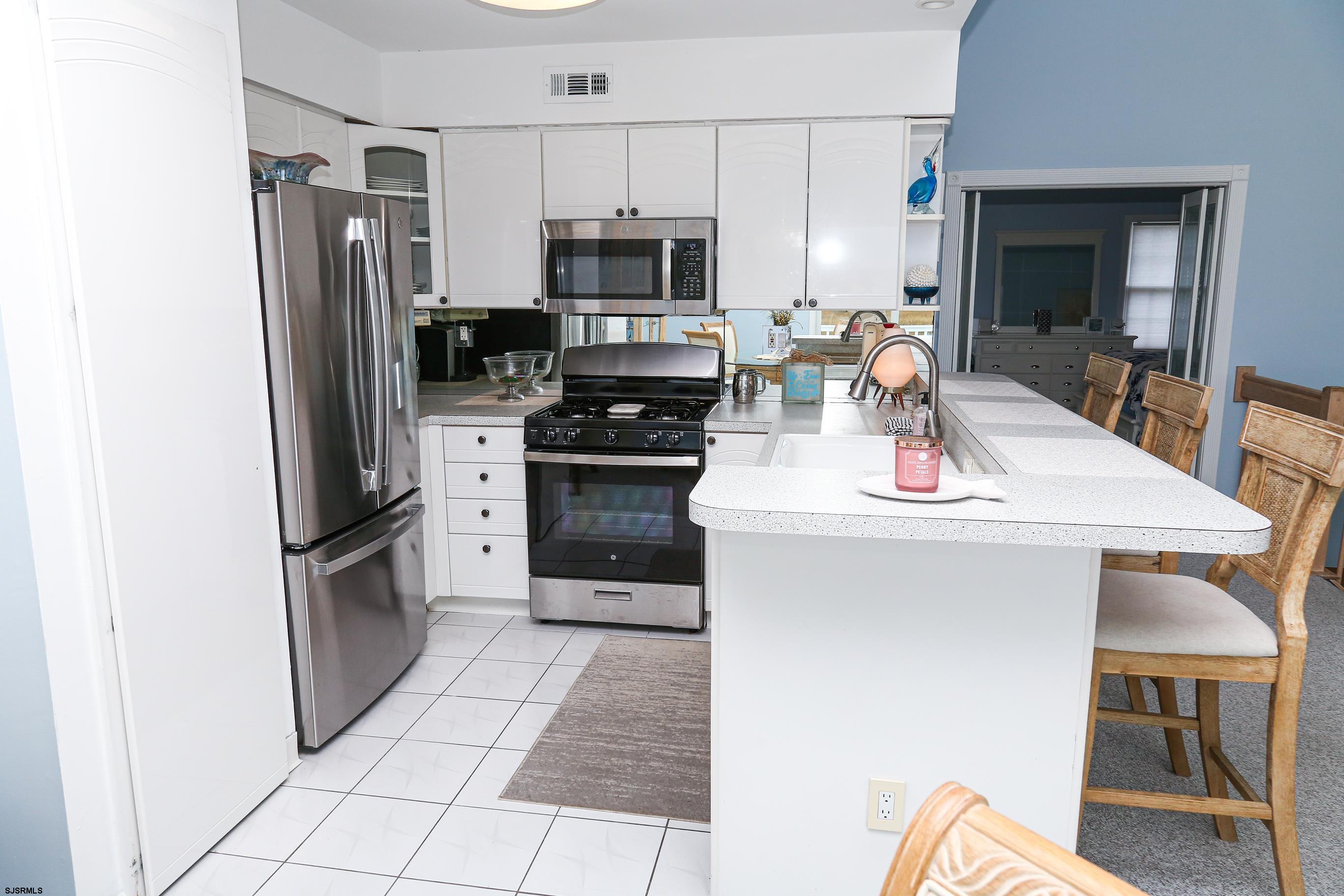 12 Gull Cove Brigantine, NJ 08203 - Photo 13 of 50 a kitchen with stainless steel appliances granite countertop a refrigerator stove top oven and sink