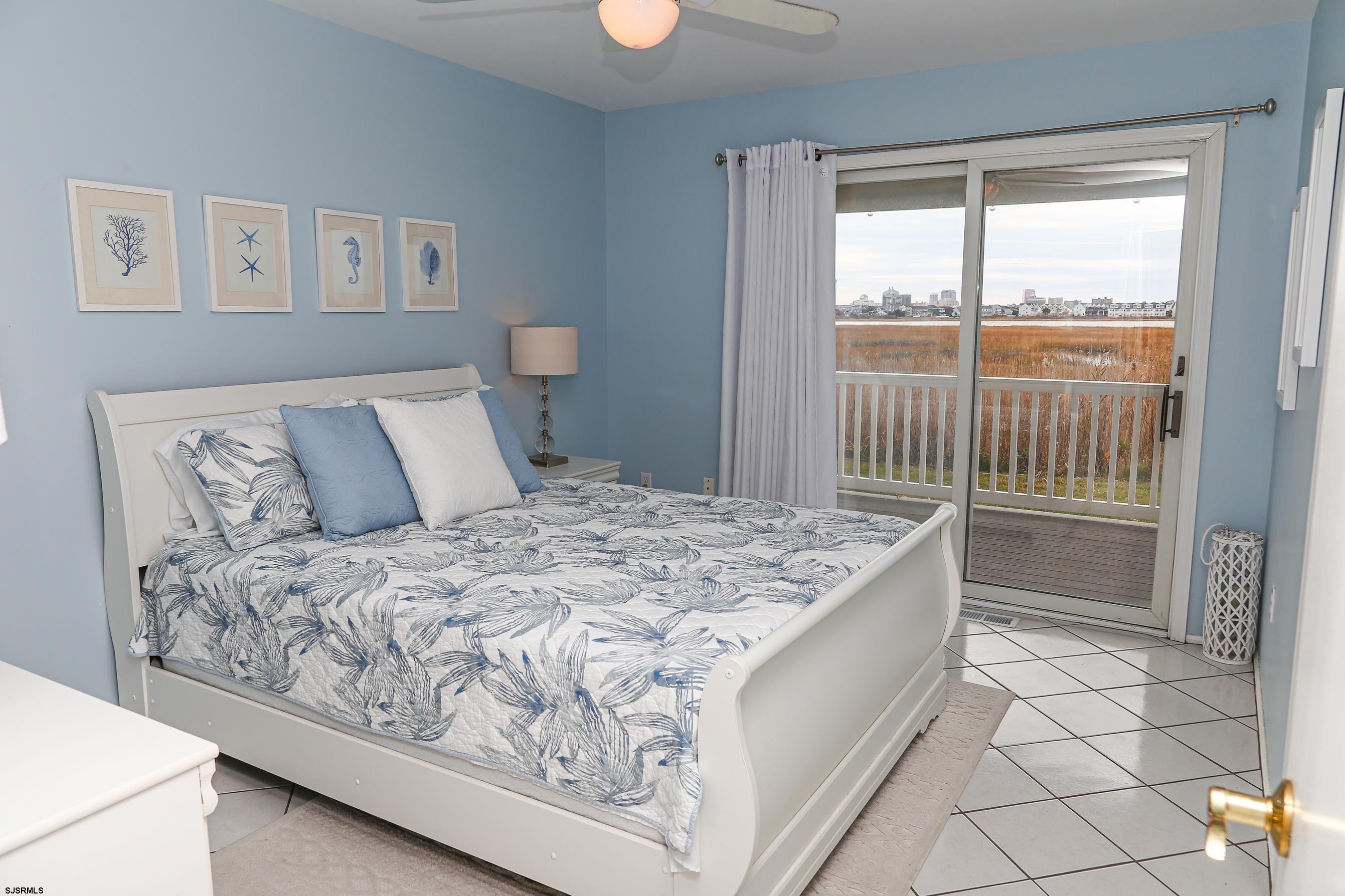 12 Gull Cove Brigantine, NJ 08203 - Photo 13 of 50 a bedroom with a bed and a window