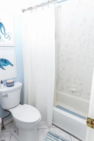 a living room with furniture a flat screen tv and a window