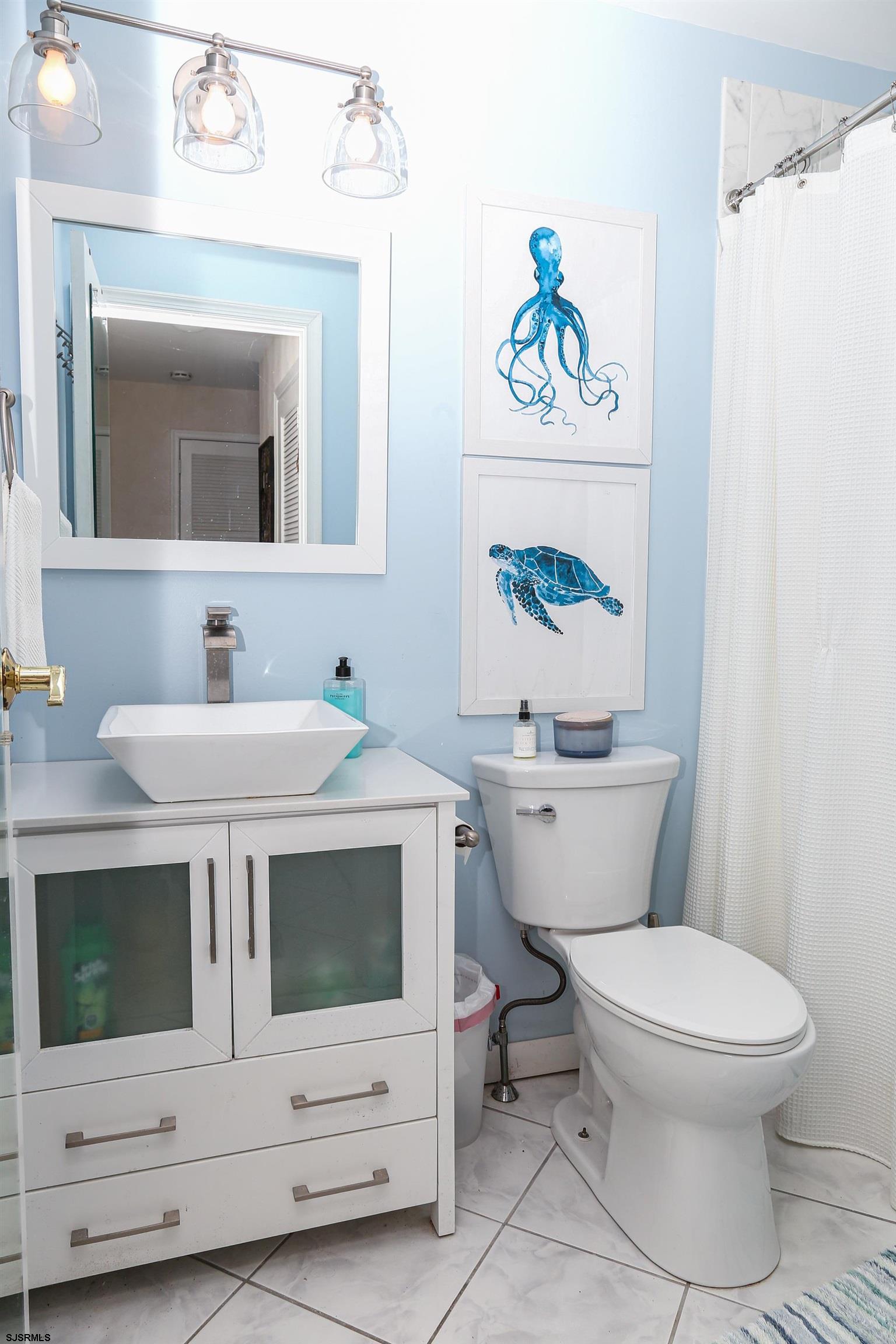 12 Gull Cove Brigantine, NJ 08203 - Photo 19 of 50 a bathroom with a sink a mirror a toilet and a mirror