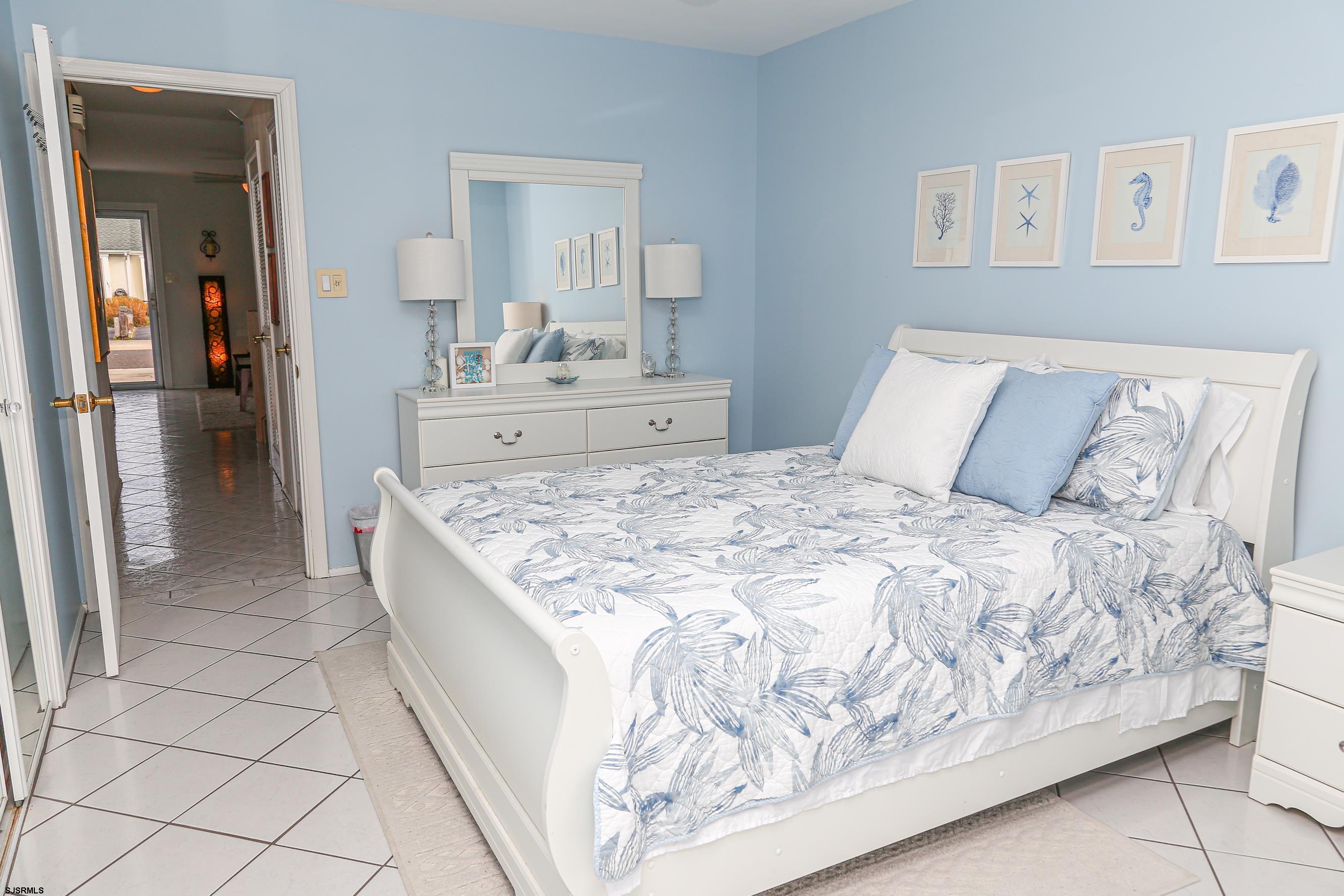 12 Gull Cove Brigantine, NJ 08203 - Photo 21 of 50 a large bed sitting in a bedroom and a mirror