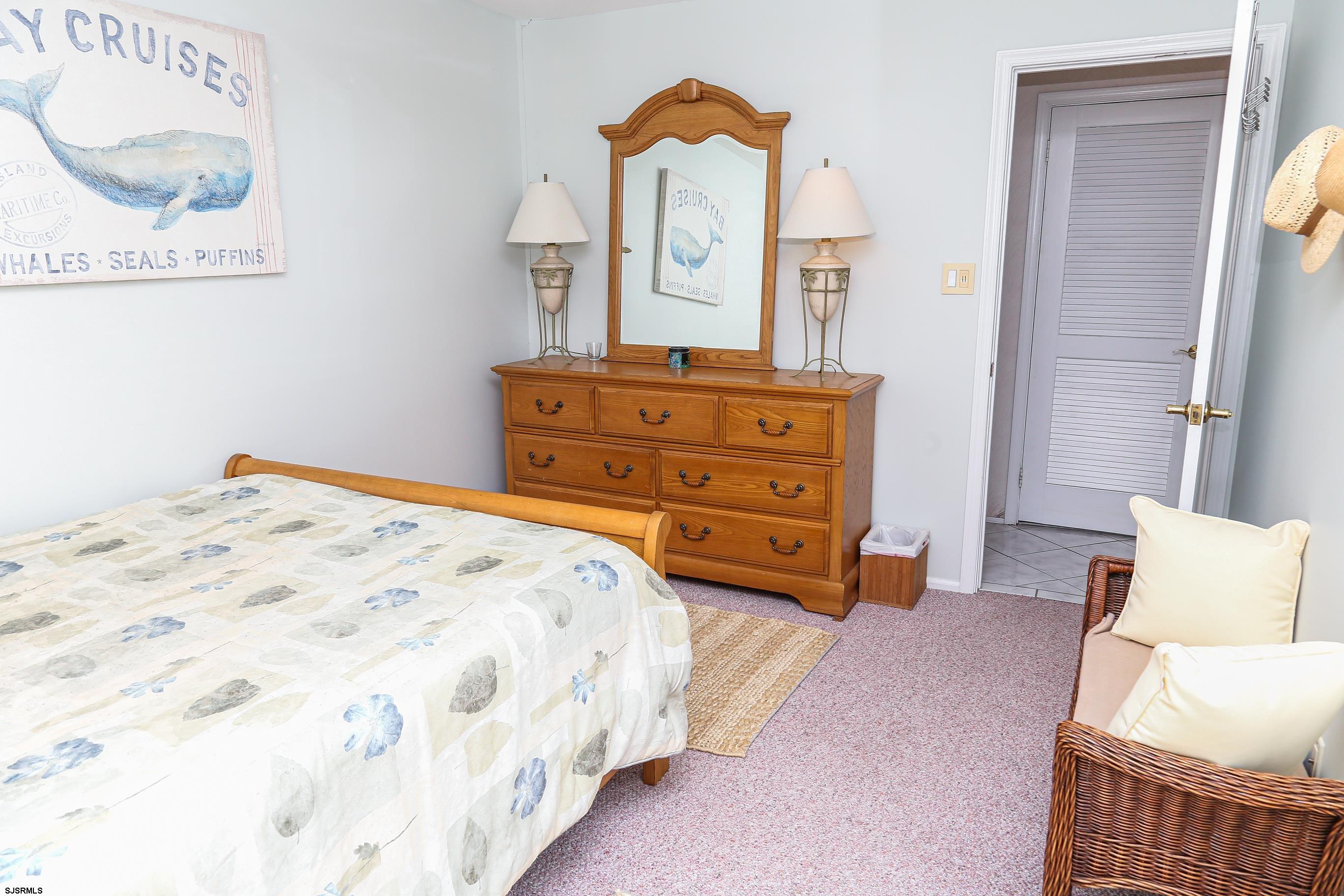 12 Gull Cove Brigantine, NJ 08203 - Photo 23 of 50 a bedroom with a bed a couch and dresser