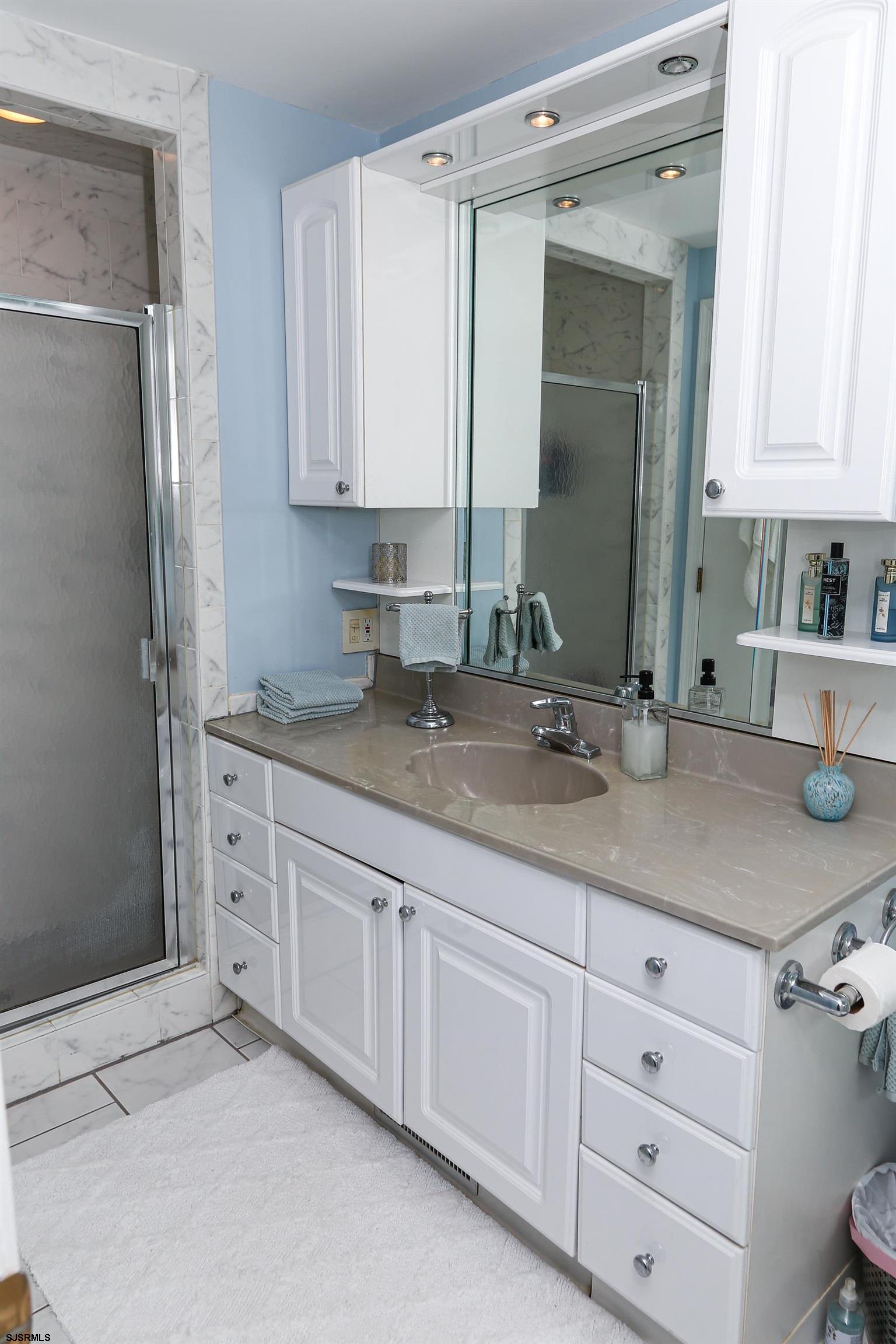 12 Gull Cove Brigantine, NJ 08203 - Photo 23 of 50 a bathroom with a granite countertop sink and a mirror