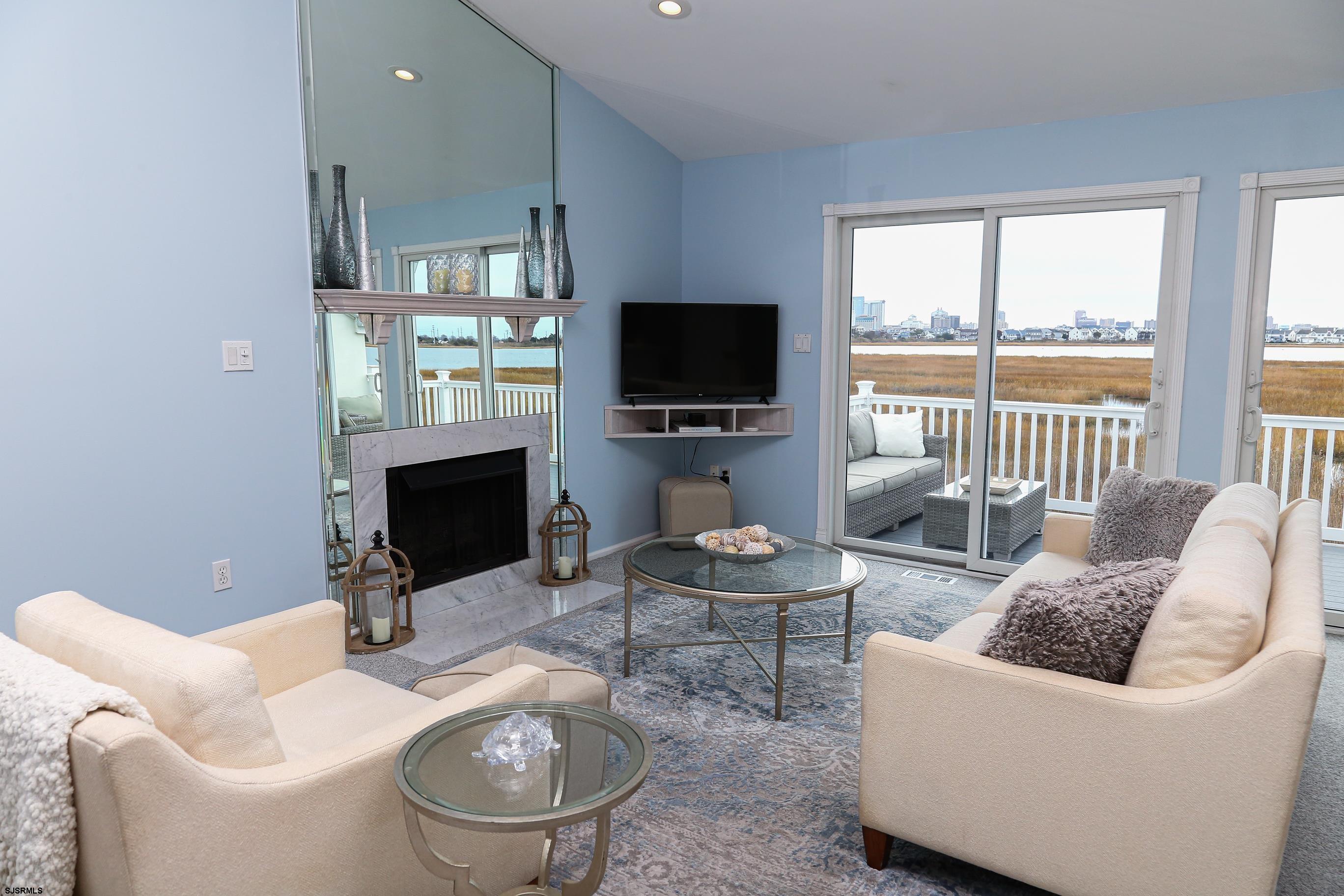 12 Gull Cove Brigantine, NJ 08203 - Photo 3 of 50 a living room with furniture a fireplace and a flat screen tv