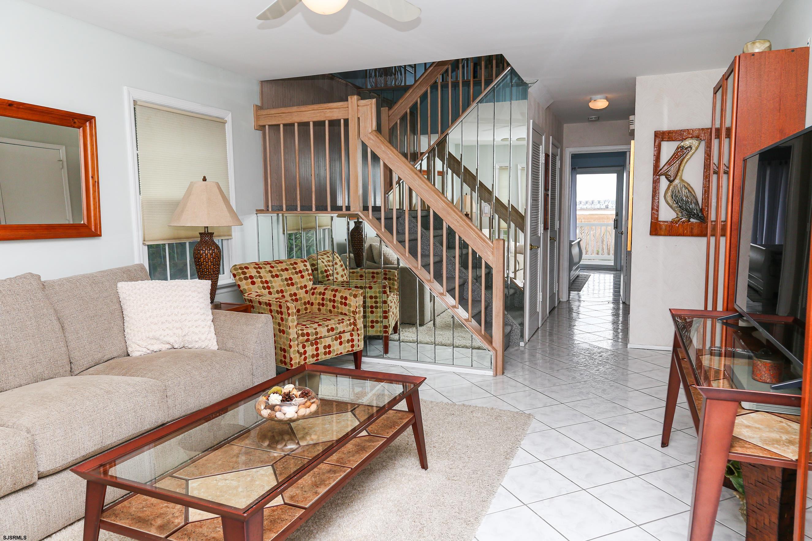 12 Gull Cove Brigantine, NJ 08203 - Photo 31 of 50 a living room with furniture a fireplace and a flat screen tv