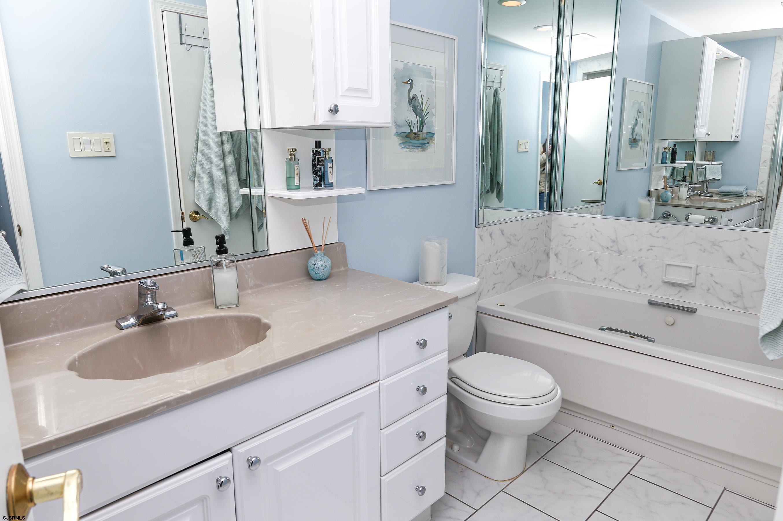 12 Gull Cove Brigantine, NJ 08203 - Photo 32 of 50 a bathroom with a granite countertop sink a toilet a mirror and bathtub