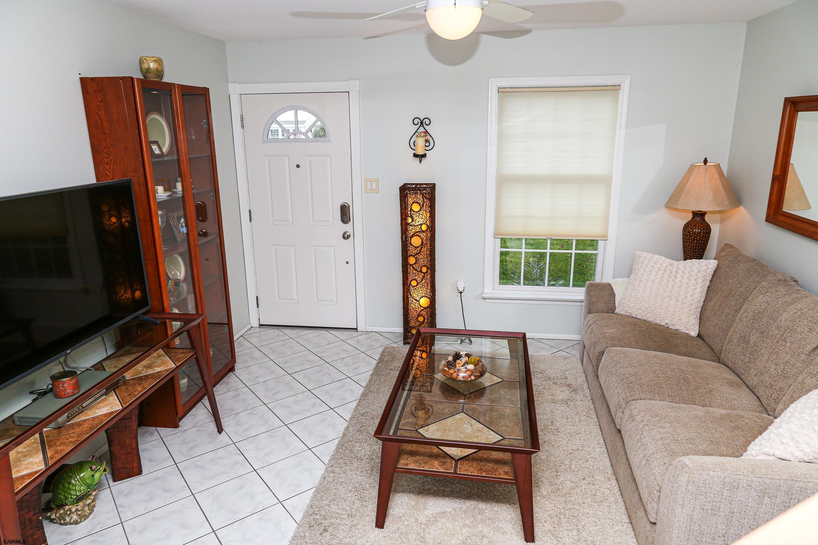12 Gull Cove Brigantine, NJ 08203 - Photo 35 of 50 a living room with furniture a flat screen tv and a window