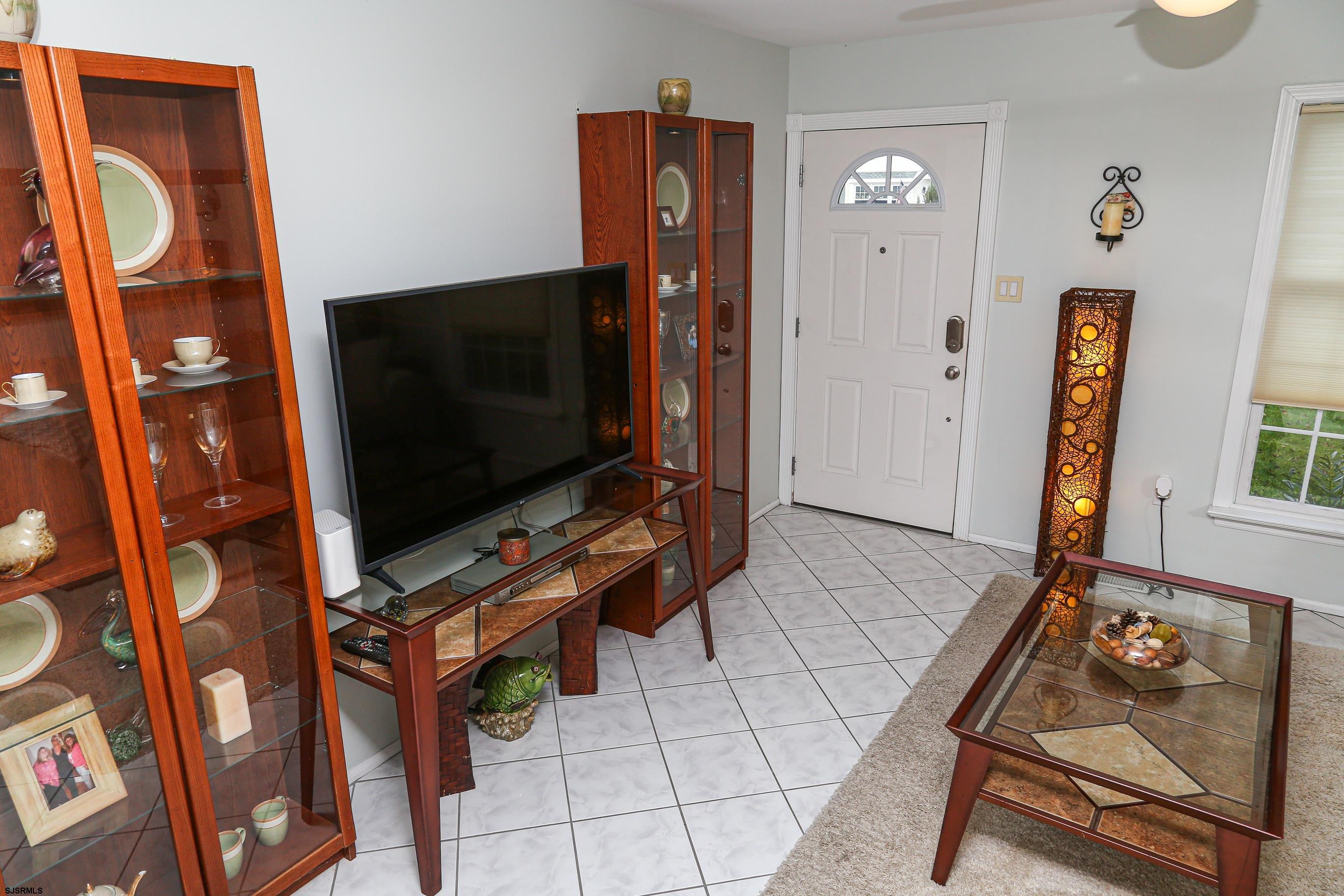 12 Gull Cove Brigantine, NJ 08203 - Photo 36 of 50 a living room with furniture and a flat screen tv
