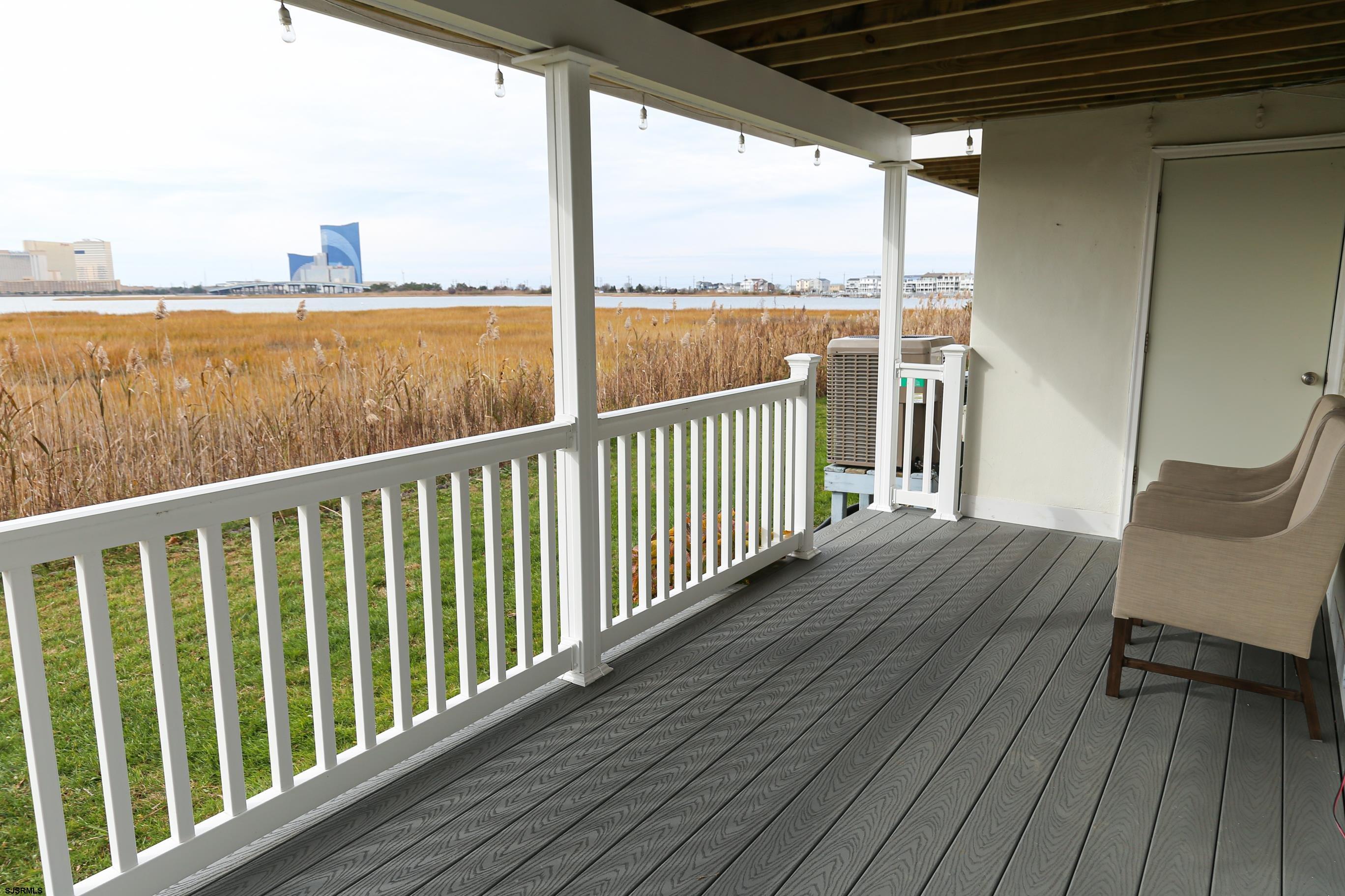 12 Gull Cove Brigantine, NJ 08203 - Photo 5 of 50 a view of a balcony with wooden floor next to a yard