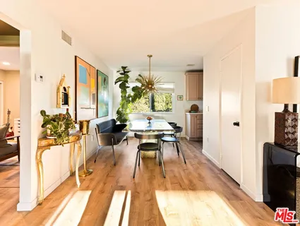 a living room with furniture windows and a flat screen tv