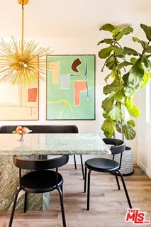 a view of a workspace room with furniture and a potted plant