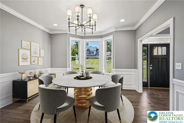 a dining room with furniture a chandelier and wooden floor
