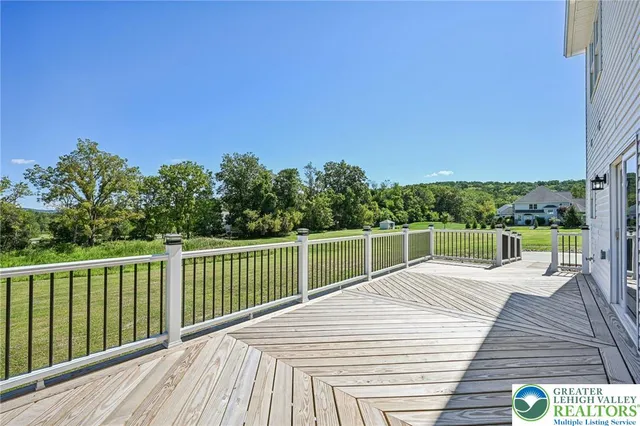 a view of a roof deck with couches and wooden floor