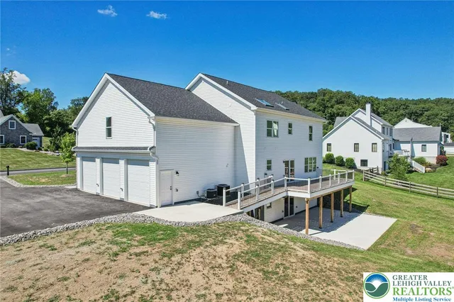a view of house with backyard outdoor seating and green space